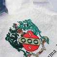 Load image into Gallery viewer, Close-up view of the detailed embroidery on a gray crewneck sweatshirt featuring the Alpha Gamma Delta sorority crest. The crest showcases a red shield surrounded by intricate green leaves.