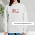 Load image into Gallery viewer, Light grey sweatshirt featuring simple sorority letters and the sorority chapter on the chest, highlighted in red to indicate which areas of the design can be customized, set against a minimalistic background.