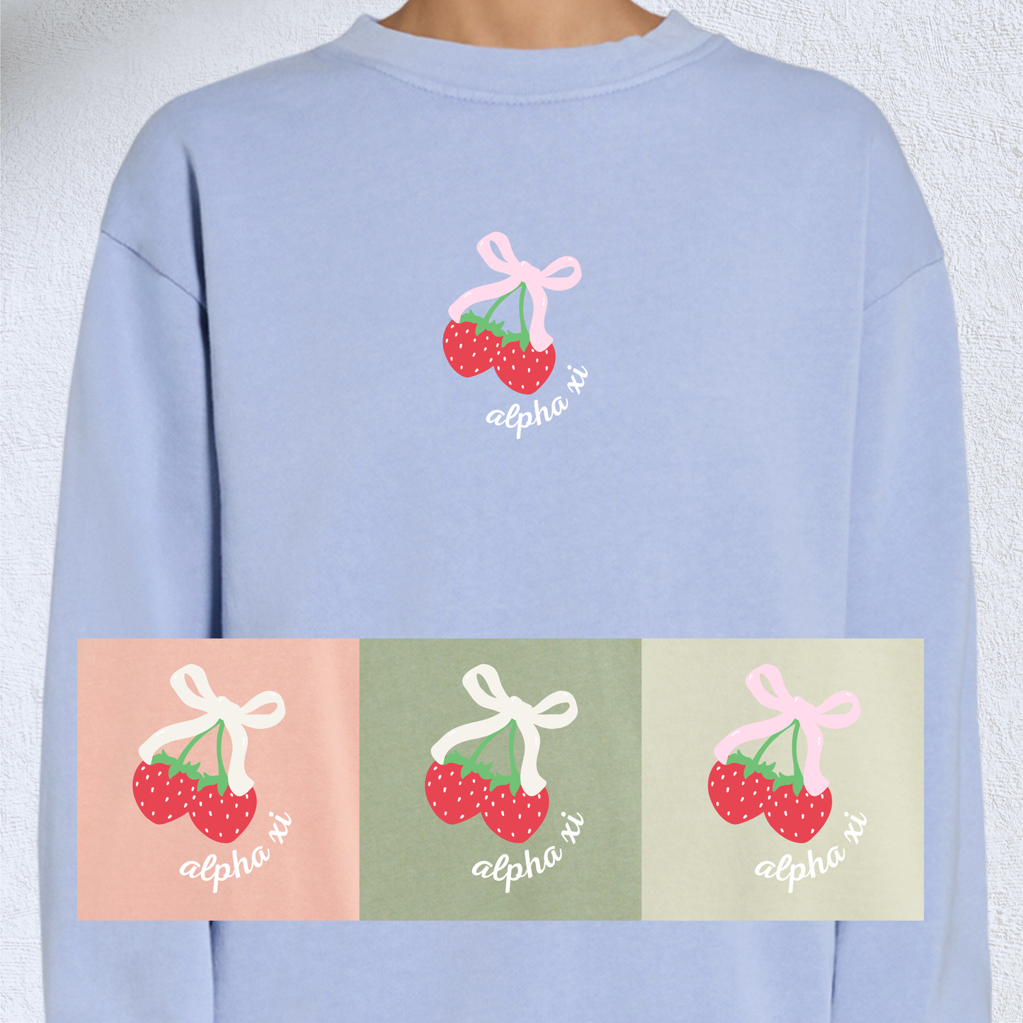 A light blue sweatshirt with a design of strawberries tied with a pink bow and the sorority name in white underneath. Other sweatshirt colors including light pink, light green, and green are shown below.