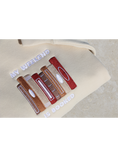 Load image into Gallery viewer, Close-up view of a beige sweatshirt embroidered with a design of multiple book spines in various brown, red, and gold shades, and the phrase 'My Weekend is Booked'. Set against a neutral background.
