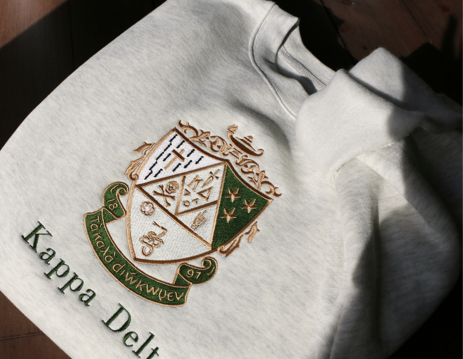 White sweatshirt with embroidered crest and 'Kappa Delta' text 