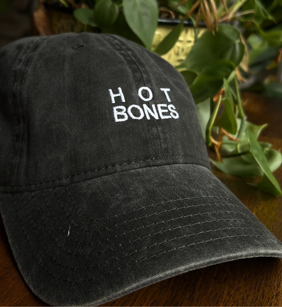 Black cap with 'HOT BONES' embroidered in white